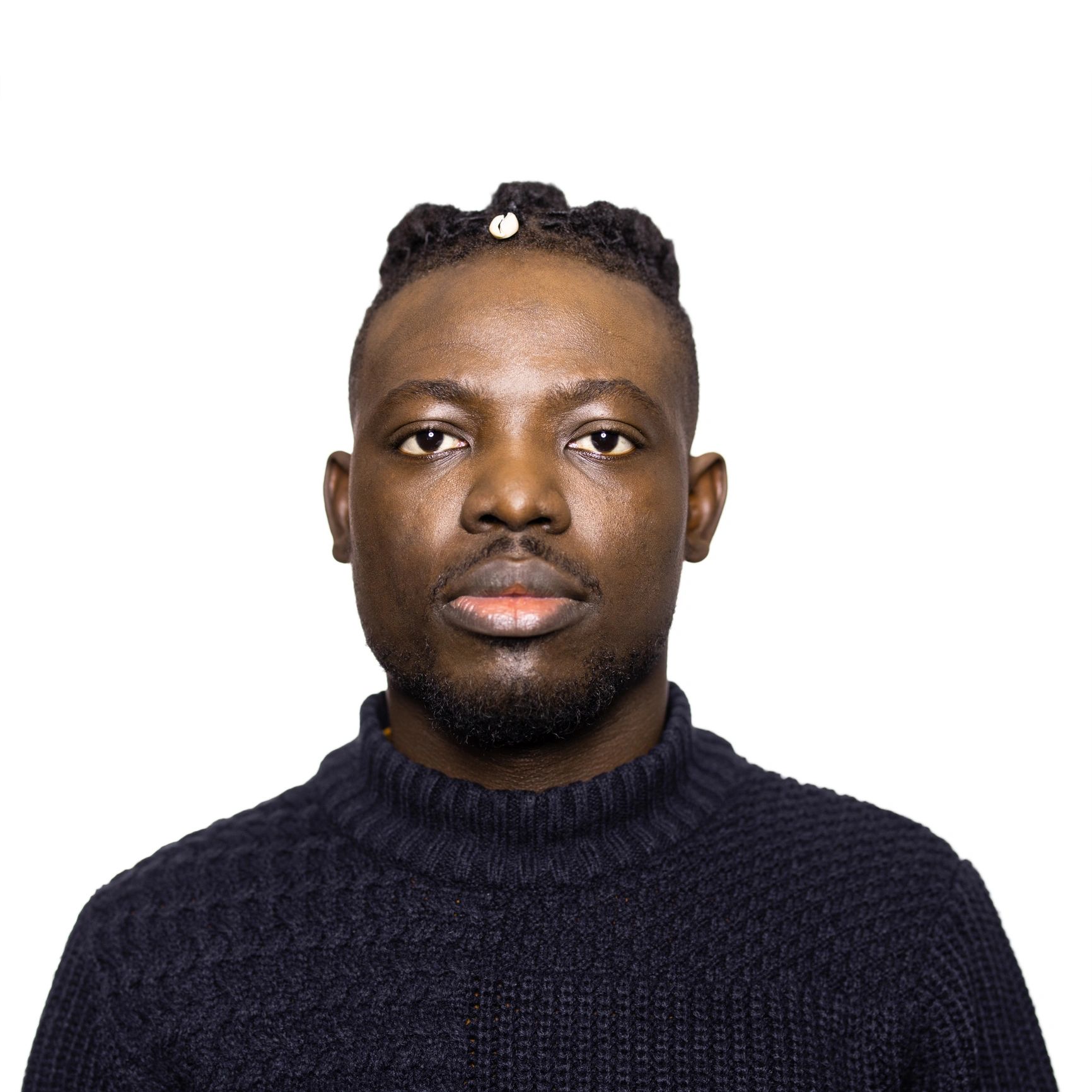 Portrait of a young man with braided hair