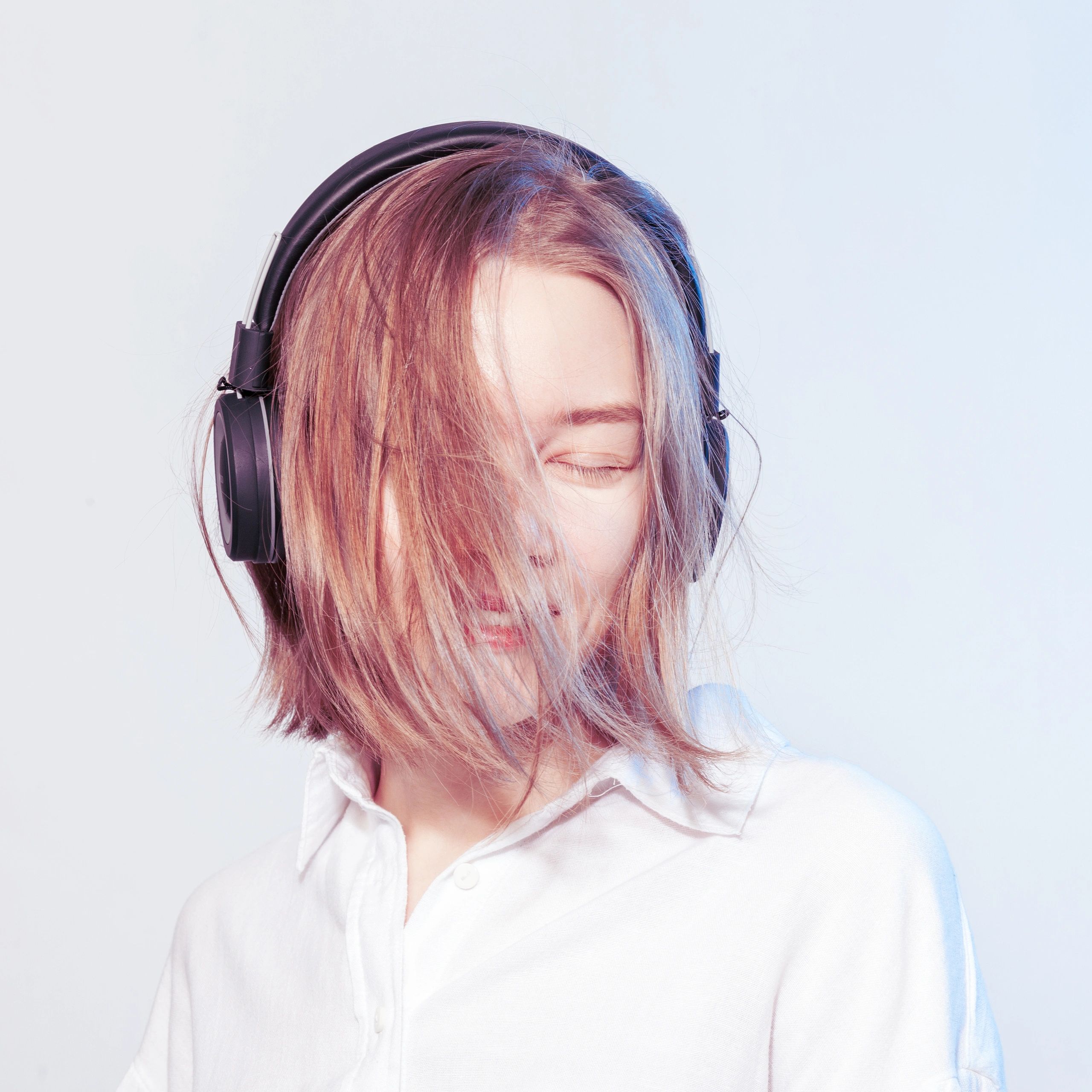 Person wearing wireless headphones enjoying music