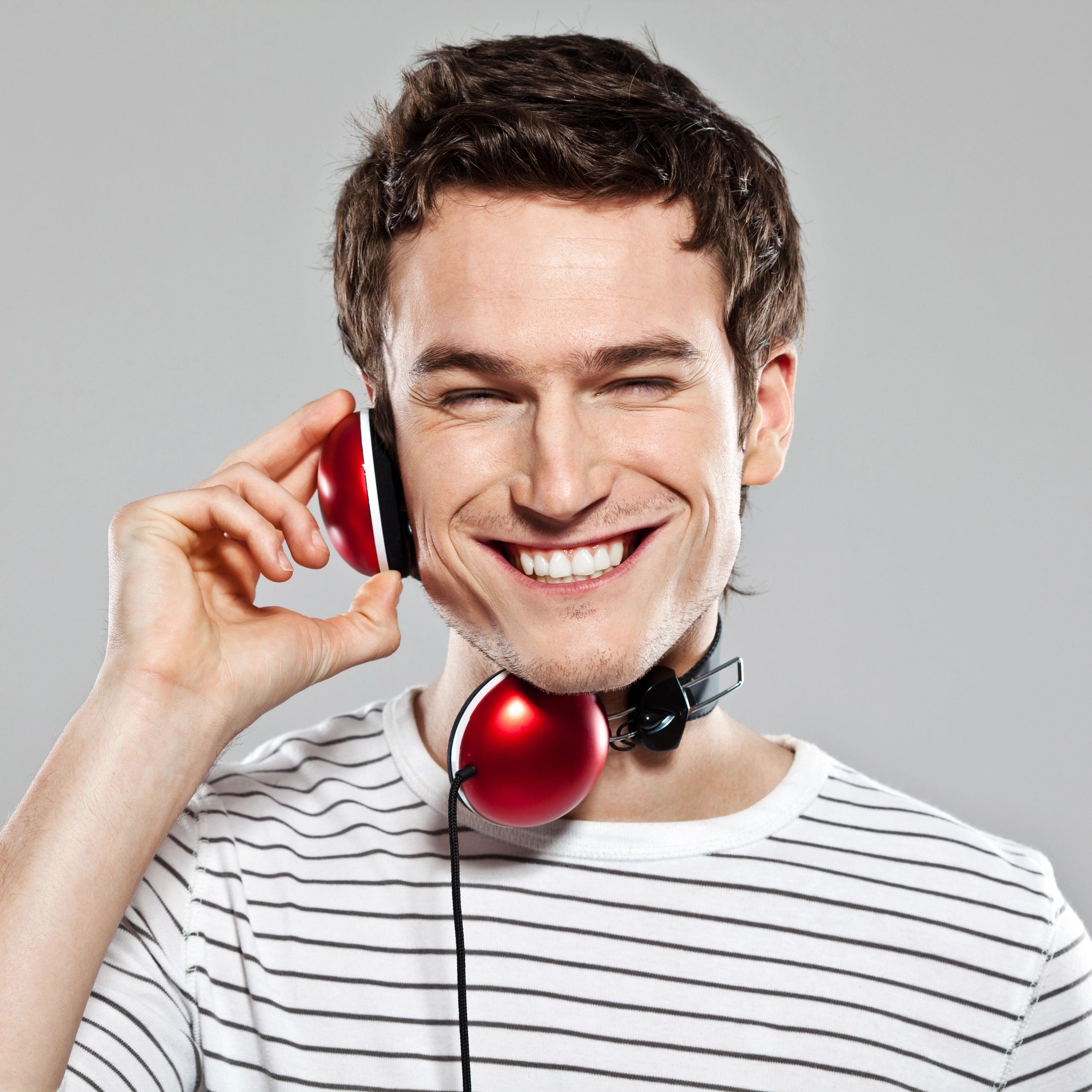 Headshot of a smiling playlist curator wearing headphones