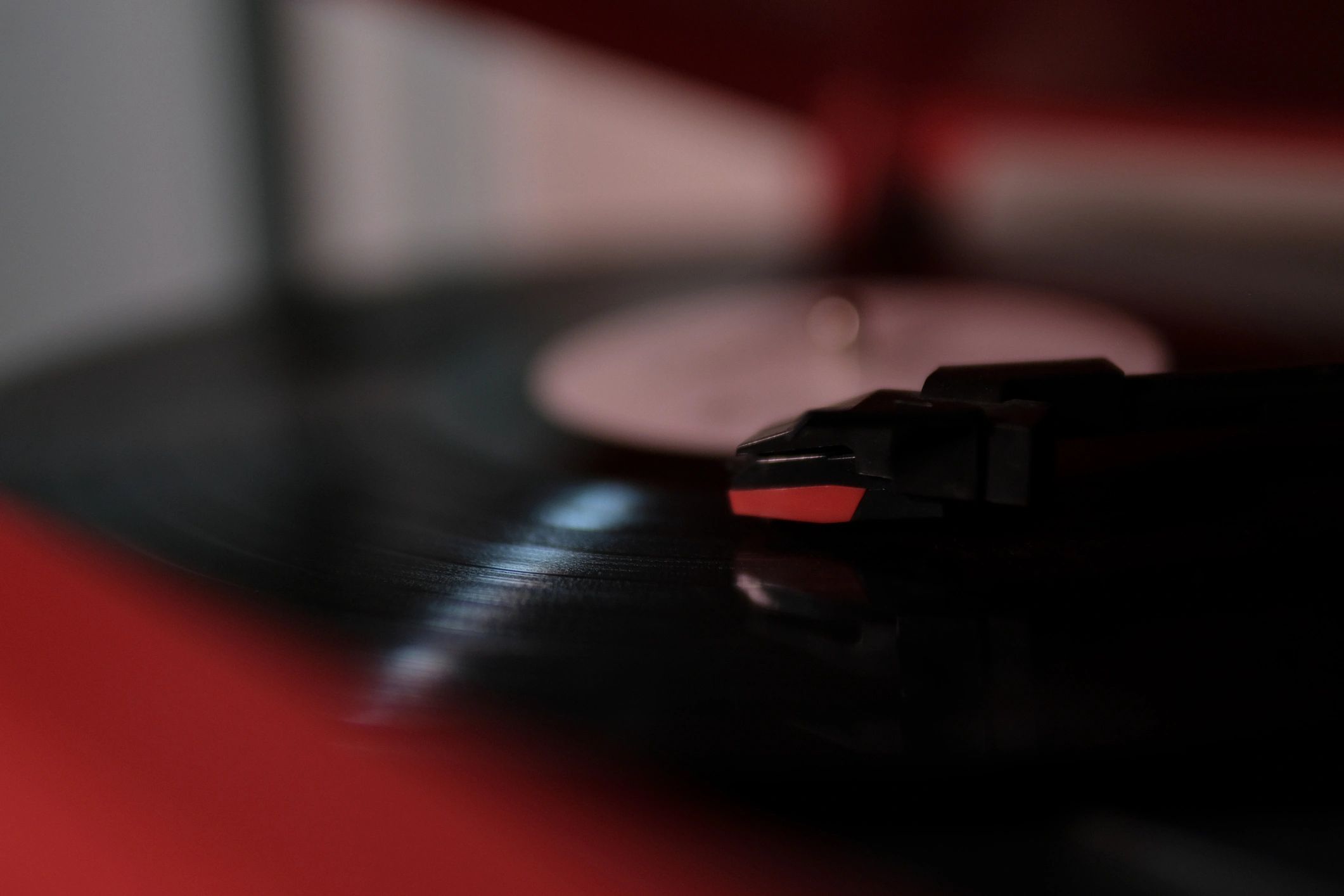 Vintage turntable needle playing a vinyl record