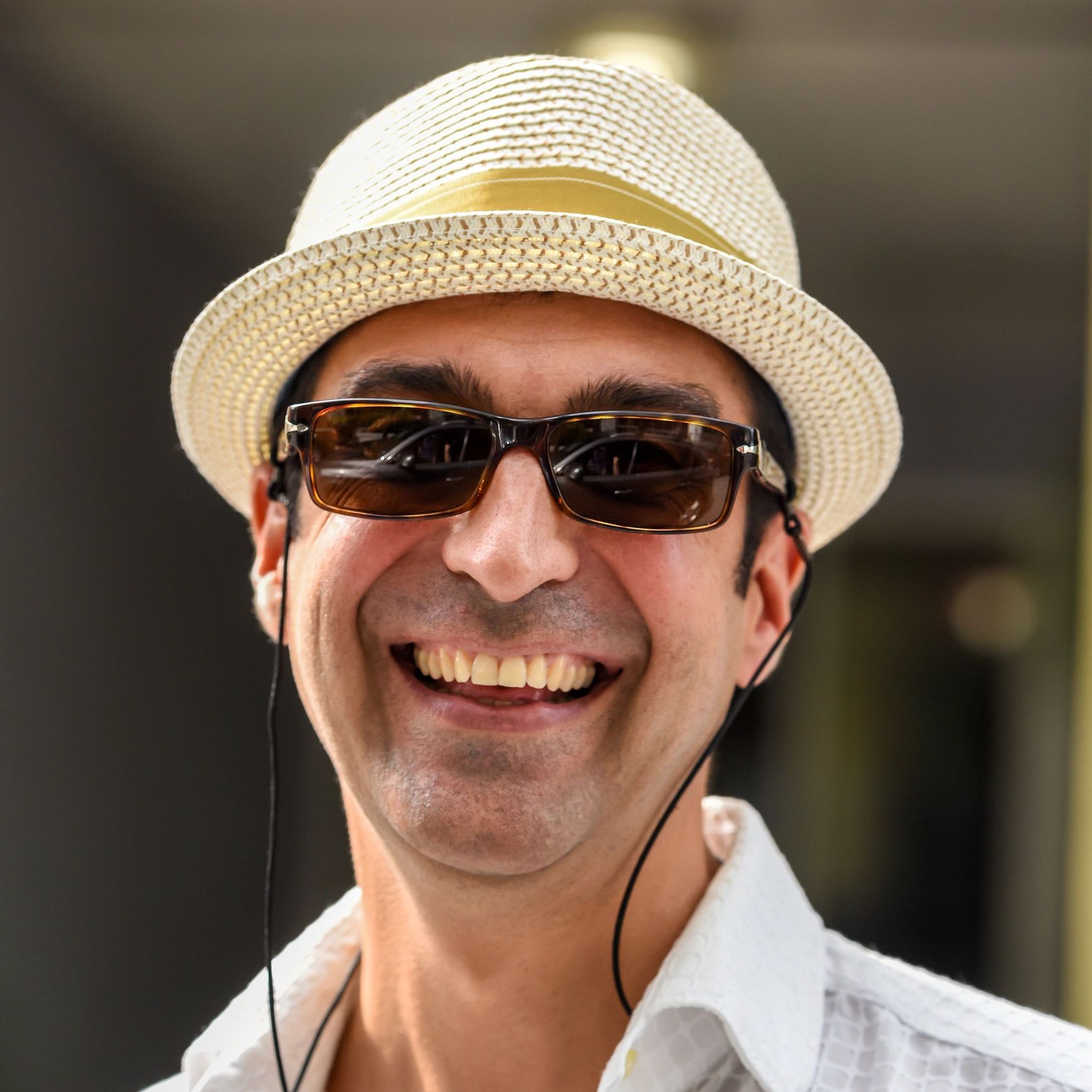 Headshot of a smiling event producer wearing sunglasses