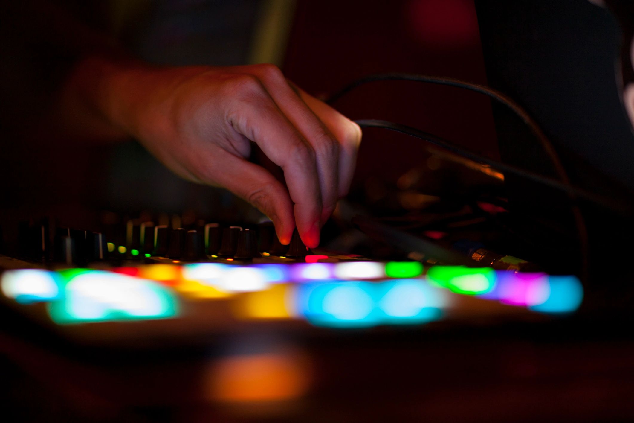 Close-up of hand adjusting a DJ mixer
